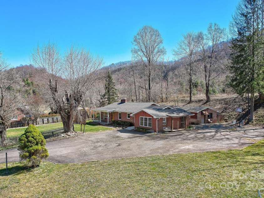 2541 Dellwood Road, Waynesville, NC 28786.  MLS# CAR4243546, YatesRealty ID 5168. Drone view showing building sitting back from the highway.