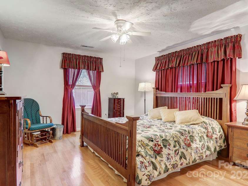 2541 Dellwood Road, Waynesville, NC 28786.  MLS# CAR4243546, YatesRealty ID 5168. Large bedroom within the home features refinished hardwood floors and plenty of storage.