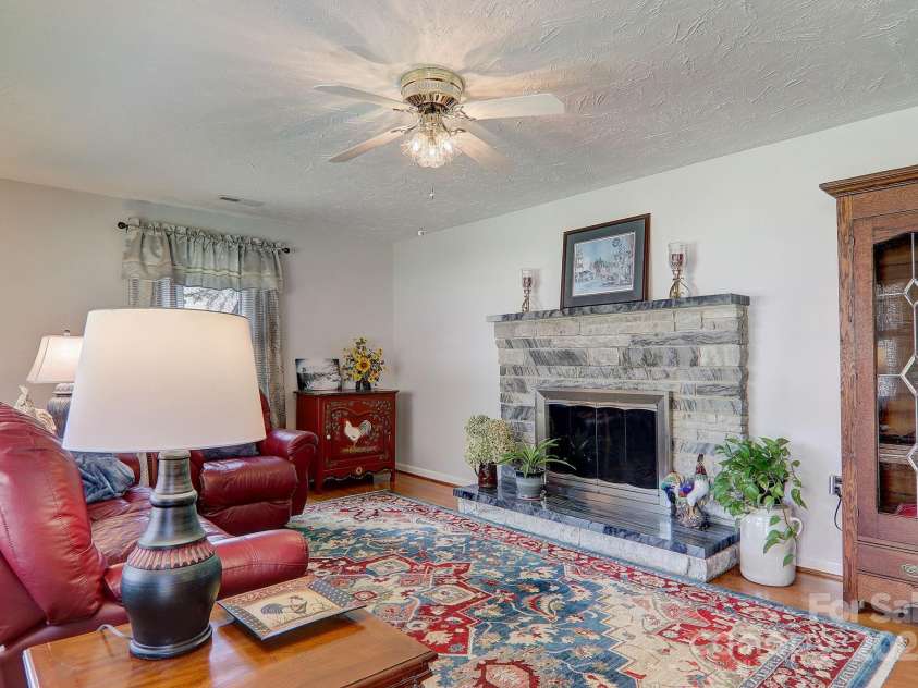 2541 Dellwood Road, Waynesville, NC 28786.  MLS# CAR4243546, YatesRealty ID 5168. Our home features  hardwood floors and Tennessee blue fieldstone and marble fireplace. The living room opens to the kitchen.