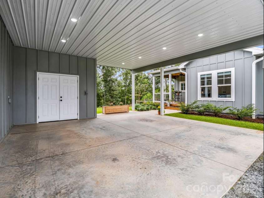 2255 Lake Adger Road, Mill Spring, NC 28756.  MLS# CAR4426062, YatesRealty ID 51693. Carport with storage room
