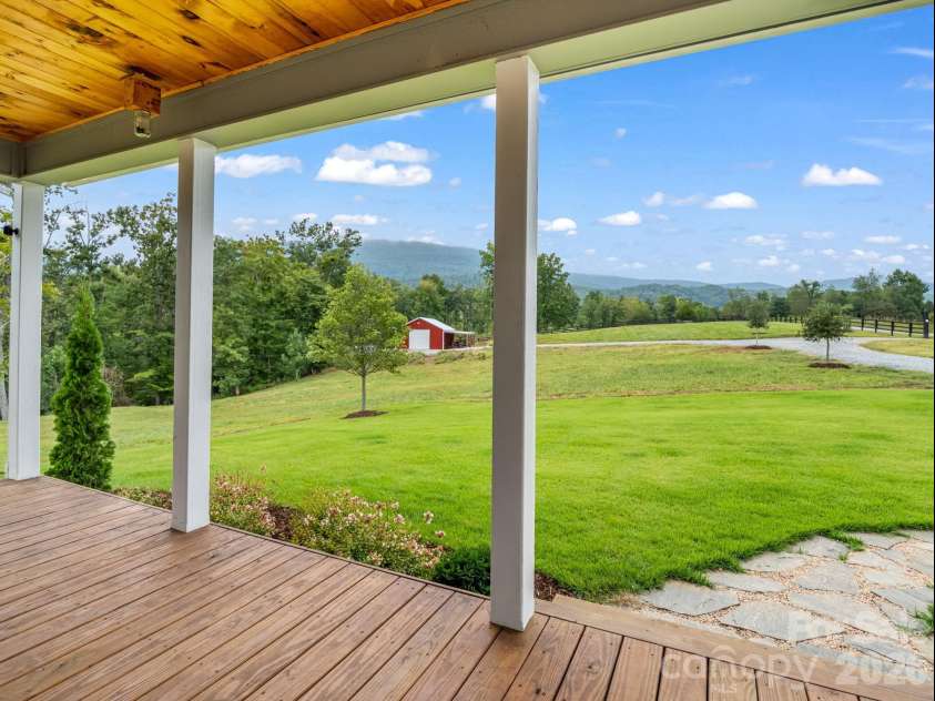 2255 Lake Adger Road, Mill Spring, NC 28756.  MLS# CAR4426062, YatesRealty ID 51693. Covered front porch with mountain views
