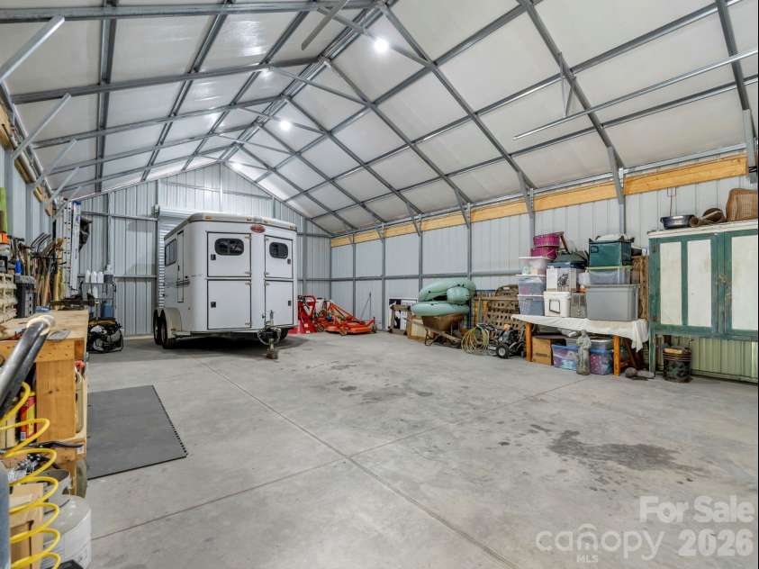 2255 Lake Adger Road, Mill Spring, NC 28756.  MLS# CAR4426062, YatesRealty ID 51693. Equipment building with roll-up doors on each side
