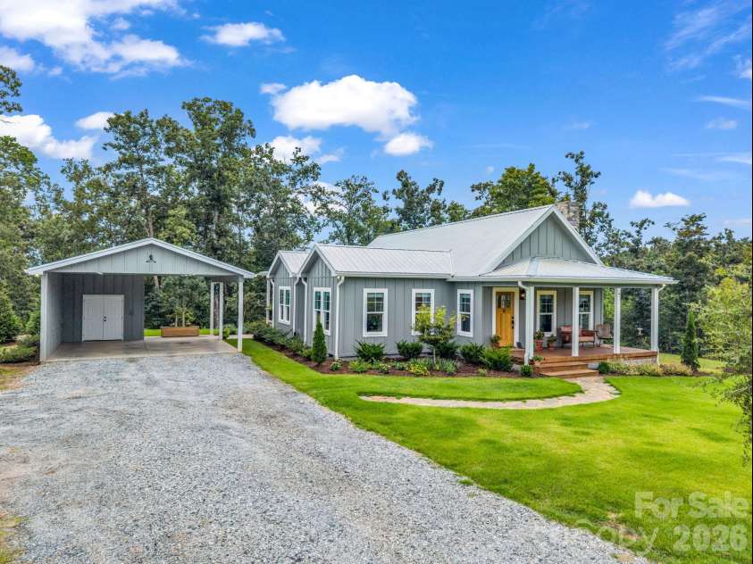2255 Lake Adger Road, Mill Spring, NC 28756.  MLS# CAR4426062, YatesRealty ID 51693. Two car carport with storage area