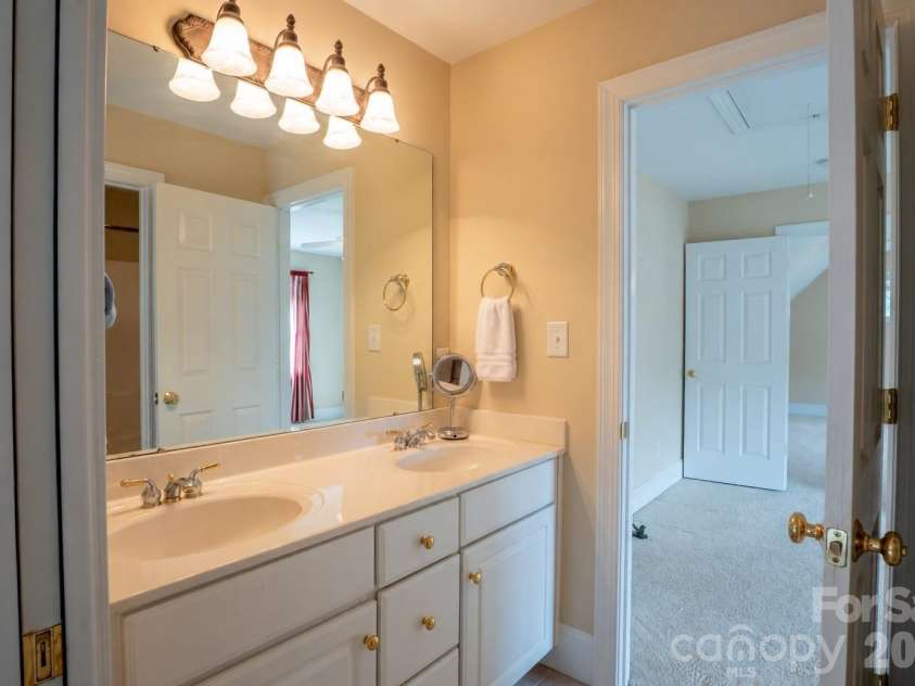 1927 Windmere Drive, Monroe, NC 28110.  MLS# CAR4418853, YatesRealty ID 51747. Dual vanity shared bathroom with shower/tub combo