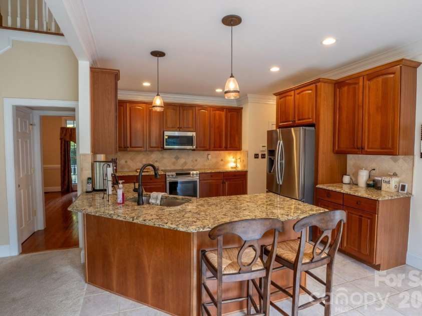 1927 Windmere Drive, Monroe, NC 28110.  MLS# CAR4418853, YatesRealty ID 51747. Kitchen with granite counter tops, 2 chair breakfast bar, and ample counter and cabinet space