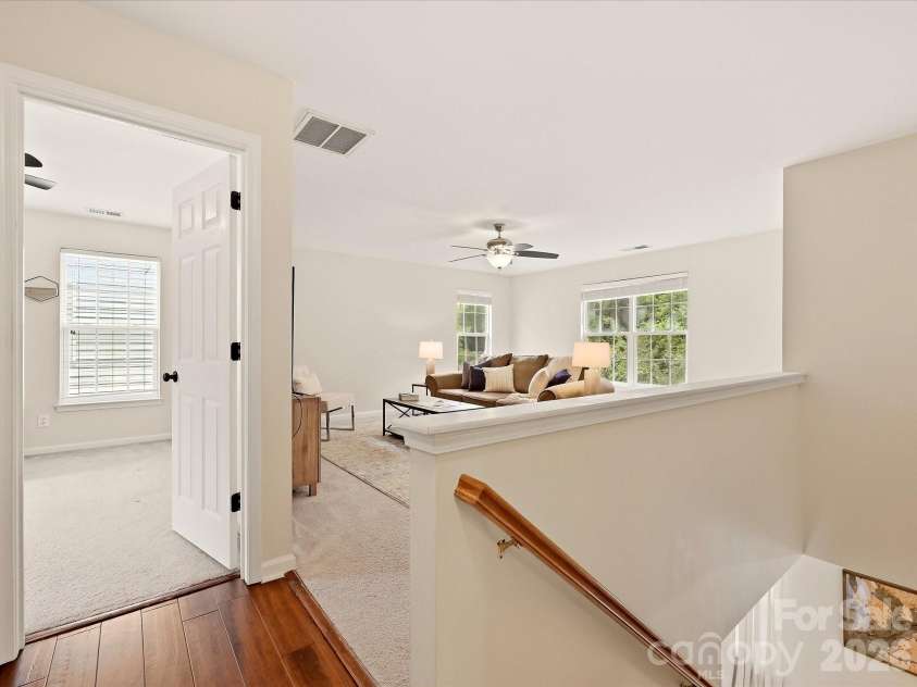 16006 Lavenham Road, Huntersville, NC 28078.  MLS# CAR4424559, YatesRealty ID 51795. The bright upper-level landing opens to a spacious loft and additional bedroom, creating a flexible transition between the home’s upstairs living spaces.