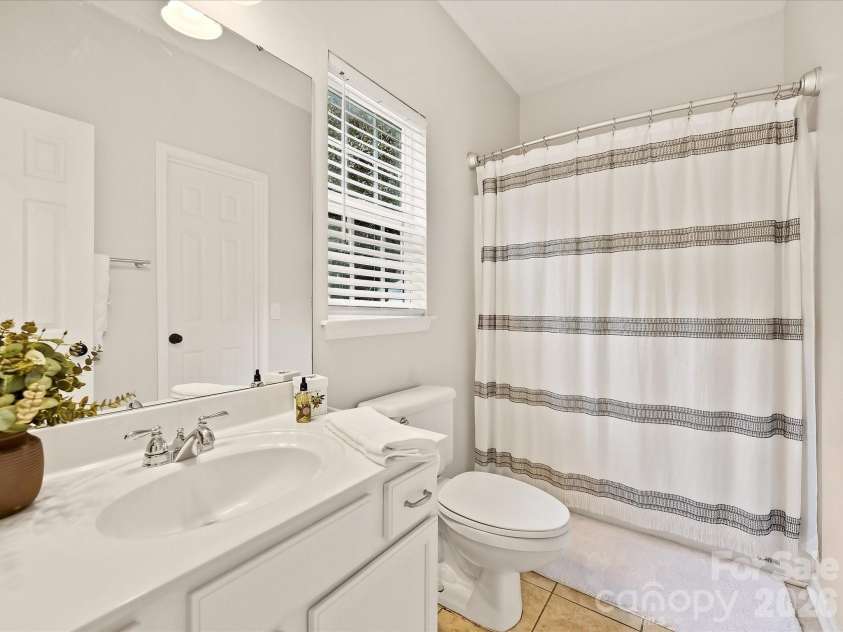 16006 Lavenham Road, Huntersville, NC 28078.  MLS# CAR4424559, YatesRealty ID 51795. The full bath on main level features a bright, clean design with a spacious vanity, tub/shower combination, and natural light from the window.