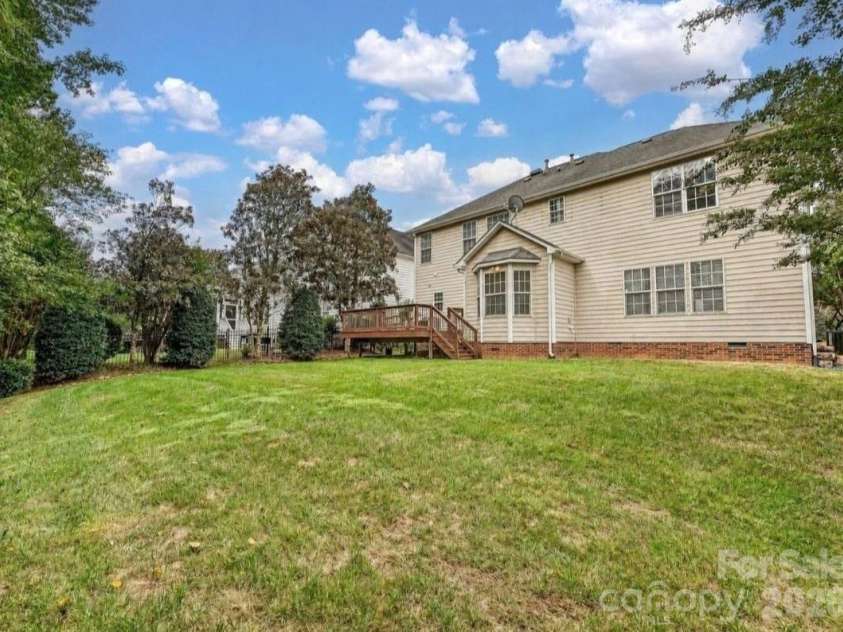 16006 Lavenham Road, Huntersville, NC 28078.  MLS# CAR4424559, YatesRealty ID 51795. The spacious backyard offers a peaceful, tree-lined setting with a large lawn and easy access to the elevated back deck.