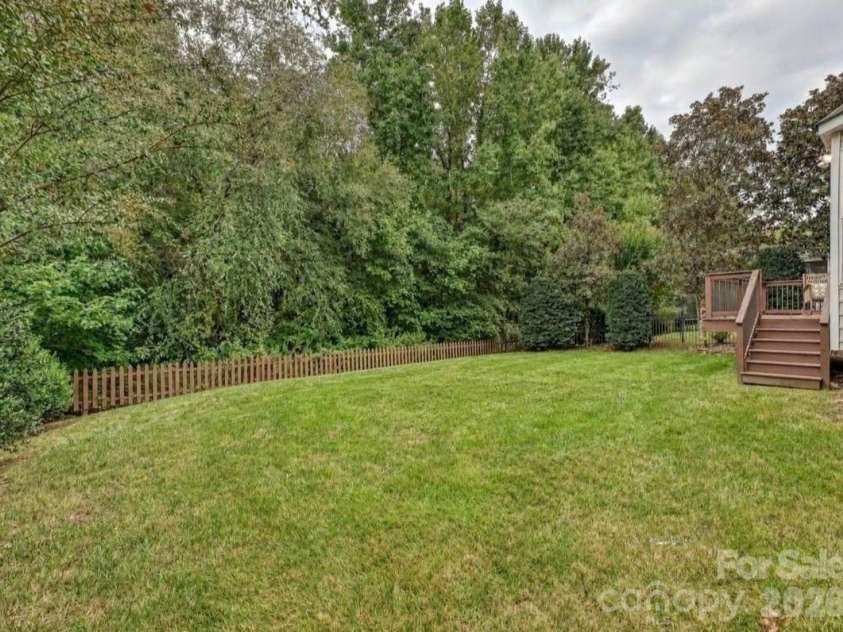16006 Lavenham Road, Huntersville, NC 28078.  MLS# CAR4424559, YatesRealty ID 51795. The spacious backyard offers a peaceful, tree-lined setting with a large lawn and easy access to the elevated back deck.