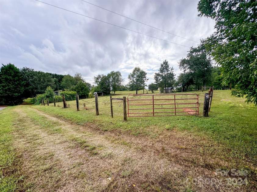 1470 River Hills Court, Taylorsville, NC 28681.  MLS# CAR4163155, YatesRealty ID 5185. Entrance to main pasture with road along bottom of property