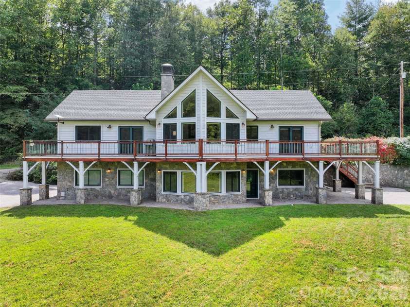 174 Marina Cove, Waynesville, NC 28785.  MLS# CAR4425258, YatesRealty ID 51963. Distinctive residence featuring cypress siding, vaulted architecture and expansive wrap-around decking.