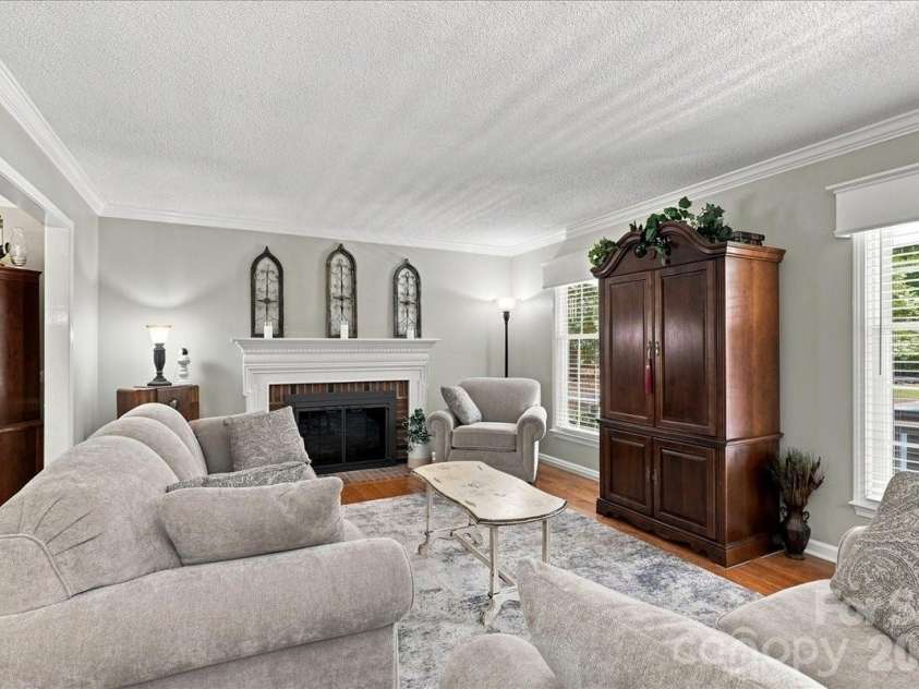 95 Scalybark Trail, Concord, NC 28027.  MLS# CAR4422844, YatesRealty ID 51966. Living room with masonry fireplace piped for gas logs