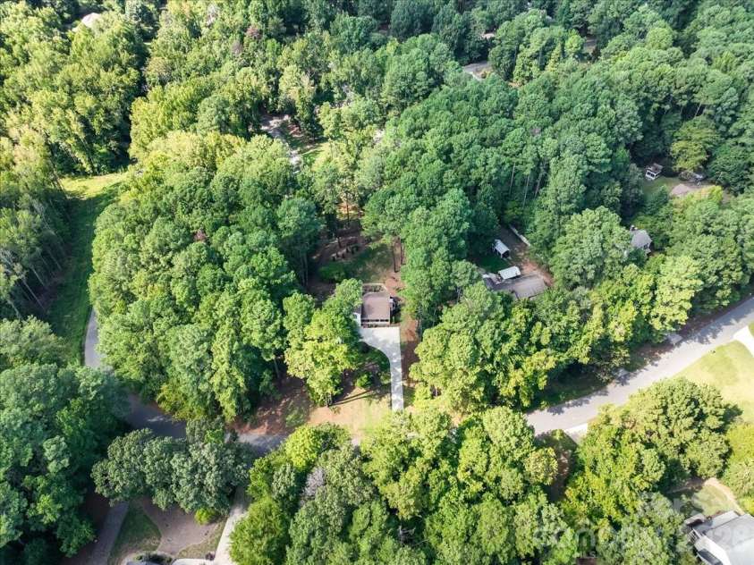 95 Scalybark Trail, Concord, NC 28027.  MLS# CAR4422844, YatesRealty ID 51966. Nestled in the trees with a little over an acre!