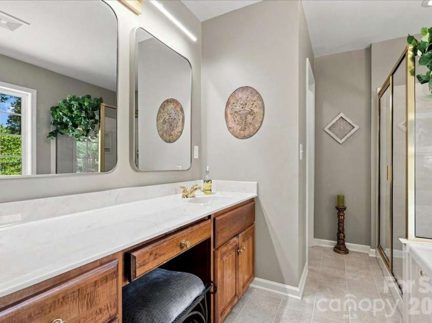 95 Scalybark Trail, Concord, NC 28027.  MLS# CAR4422844, YatesRealty ID 51966. Primary bath with walk in shower and tub