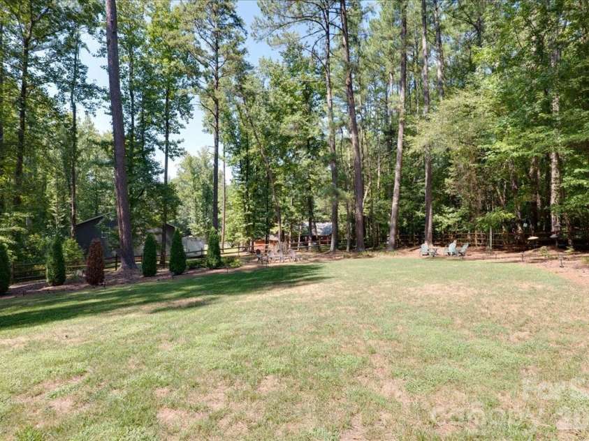 95 Scalybark Trail, Concord, NC 28027.  MLS# CAR4422844, YatesRealty ID 51966. Private backyard surrounded by beautiful landscaping and lots of trees.
