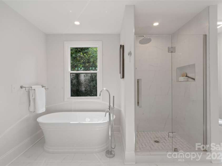8503 Foxbridge Drive, Matthews, NC 28104.  MLS# CAR4179020, YatesRealty ID 5201. Soaking tub and shower in the primary bathroom.