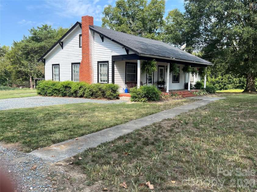 5810 Wolf Pond Road, Monroe, NC 28112.  MLS# CAR4426485, YatesRealty ID 52012. Side view of property - house built in 1945