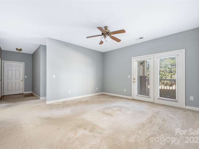 16312 Redstone Mountain Lane, Charlotte, NC 28277.  MLS# CAR4237110, YatesRealty ID 5202. Living room with door leading to covered porch