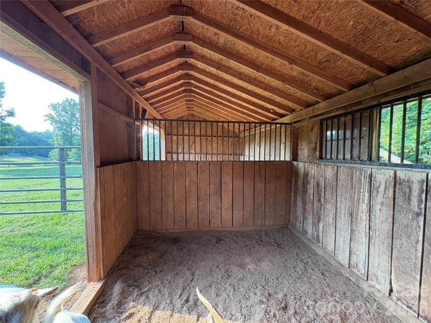 27 & 56 Troy Lane, Tryon, NC 28782.  MLS# CAR4426480, YatesRealty ID 52041. Barn stalls offer good, covered space with excellent ventilation.