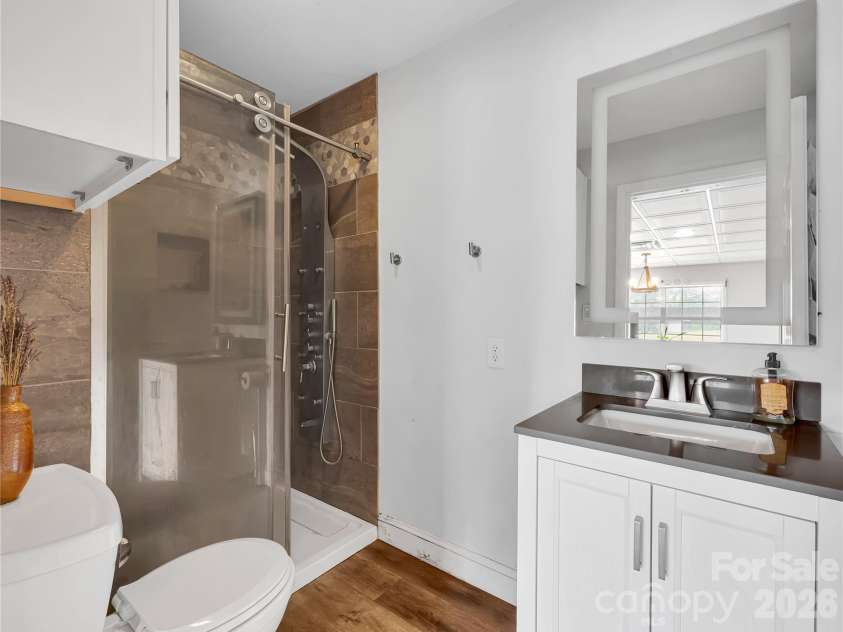 27 & 56 Troy Lane, Tryon, NC 28782.  MLS# CAR4426480, YatesRealty ID 52041. Full bath with shower in guest house.