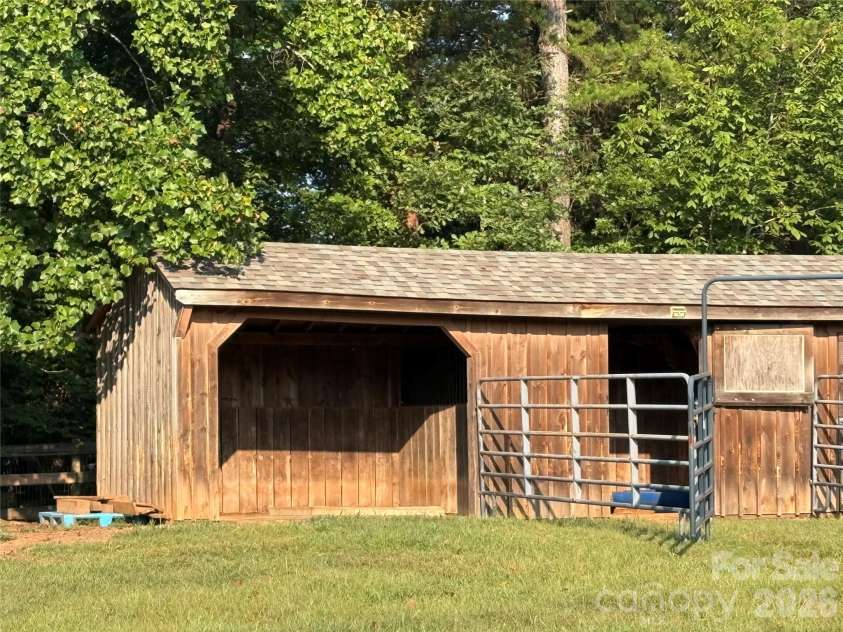 27 & 56 Troy Lane, Tryon, NC 28782.  MLS# CAR4426480, YatesRealty ID 52041. Great small barn with a run-in stall, a second stall, and a small storage room.