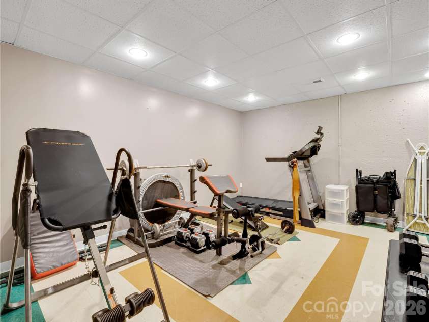 27 & 56 Troy Lane, Tryon, NC 28782.  MLS# CAR4426480, YatesRealty ID 52041. Heated and cooled exercise room.