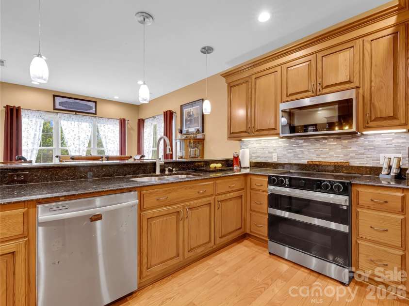 27 & 56 Troy Lane, Tryon, NC 28782.  MLS# CAR4426480, YatesRealty ID 52041. Large, bright kitchen is well designed and opens out to the breakfast room.