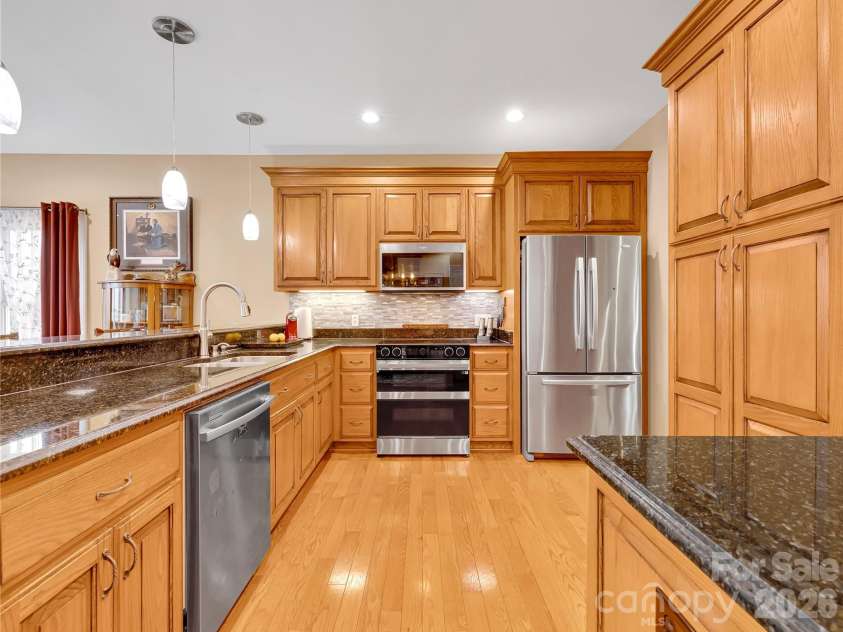 27 & 56 Troy Lane, Tryon, NC 28782.  MLS# CAR4426480, YatesRealty ID 52041. Pristine kitchen with tons of storage, granite countertops, range with double ovens and high quality appliances. All of the cabinetry in this home was custom built, including the bathroom cabinets, the built-ins in the laund