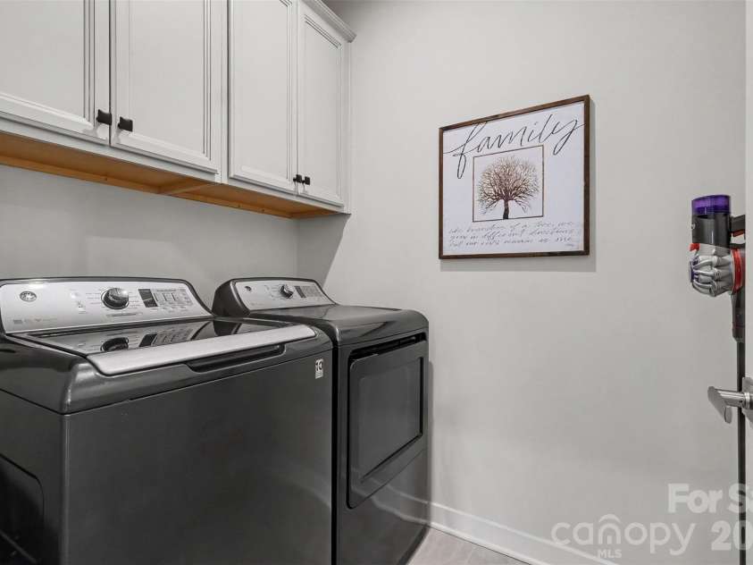 6513 Cumberland Drive, Harrisburg, NC 28075.  MLS# CAR4426198, YatesRealty ID 52070. Laundry room with cabinets
