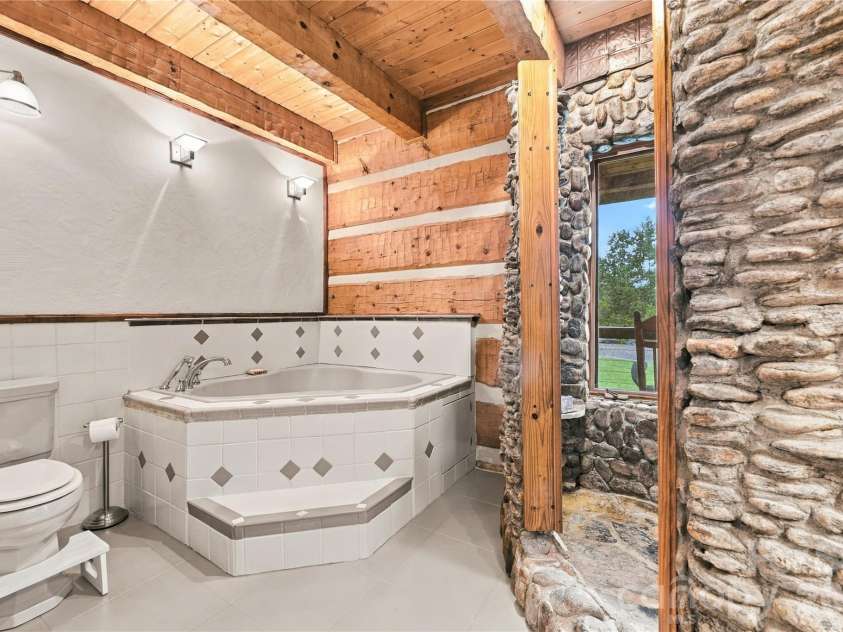 237 Murdock Road, Bakersville, NC 28705.  MLS# CAR4425998, YatesRealty ID 52099. Rock Shower bathroom