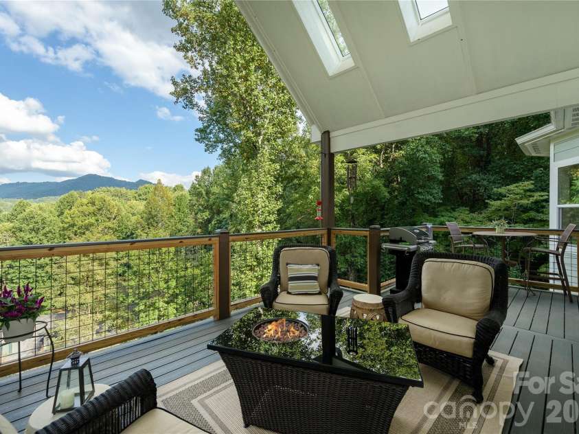 110 Quail Mountain Lane, Waynesville, NC 28786.  MLS# CAR4424241, YatesRealty ID 52123. Main level spacious covered deck