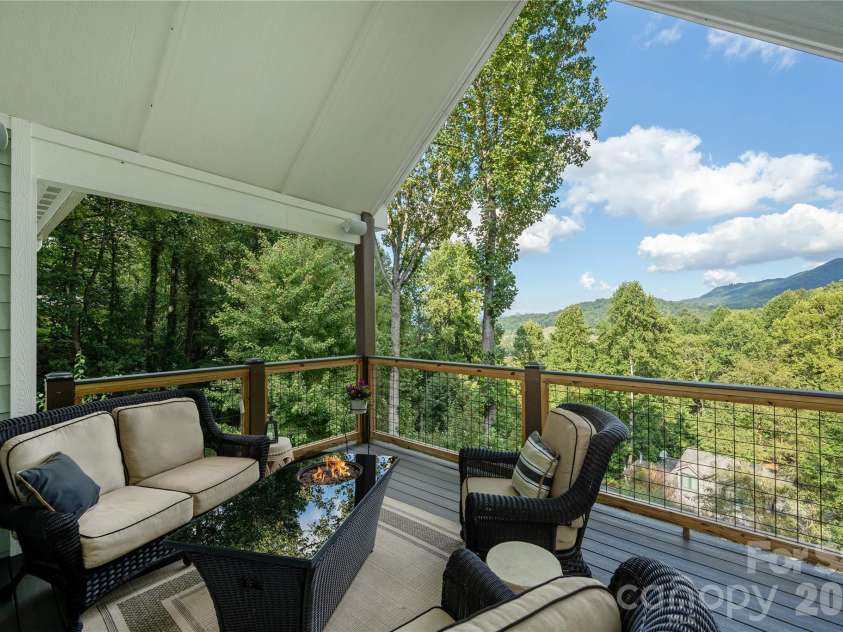 110 Quail Mountain Lane, Waynesville, NC 28786.  MLS# CAR4424241, YatesRealty ID 52123. Main level spacious covered deck with fire table