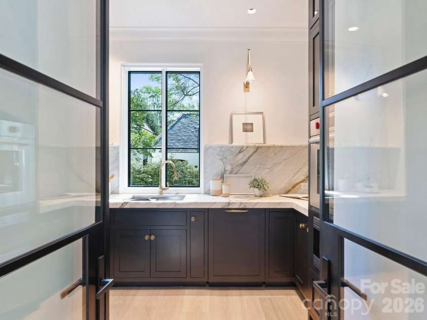 600 Hermitage Road, Charlotte, NC 28207.  MLS# CAR4422657, YatesRealty ID 52142. Custom steel doors into the scullery