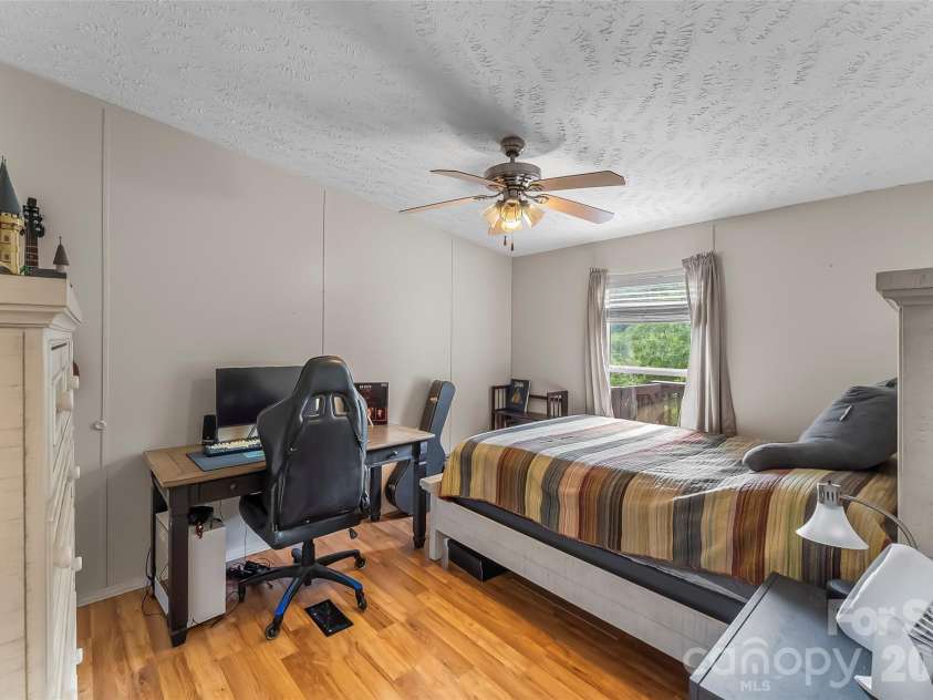 245 Merry Way, Clyde, NC 28721.  MLS# CAR4419042, YatesRealty ID 52197. Bedroom 2 with walk-in closet