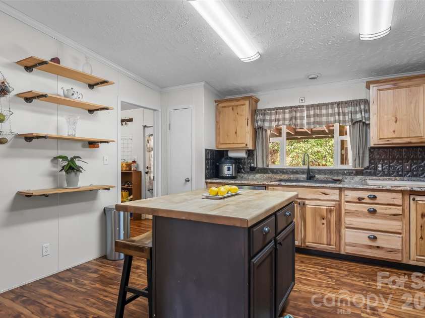 245 Merry Way, Clyde, NC 28721.  MLS# CAR4419042, YatesRealty ID 52197. Kitchen island with seating