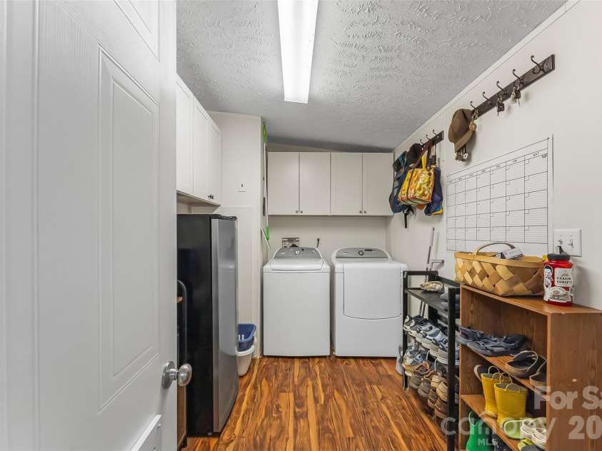 245 Merry Way, Clyde, NC 28721.  MLS# CAR4419042, YatesRealty ID 52197. Large laundry room / mud room with cabinets