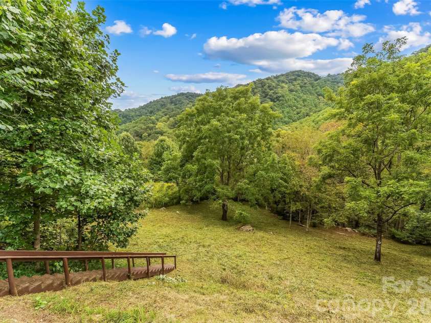 245 Merry Way, Clyde, NC 28721.  MLS# CAR4419042, YatesRealty ID 52197. Stairs to the pasture area