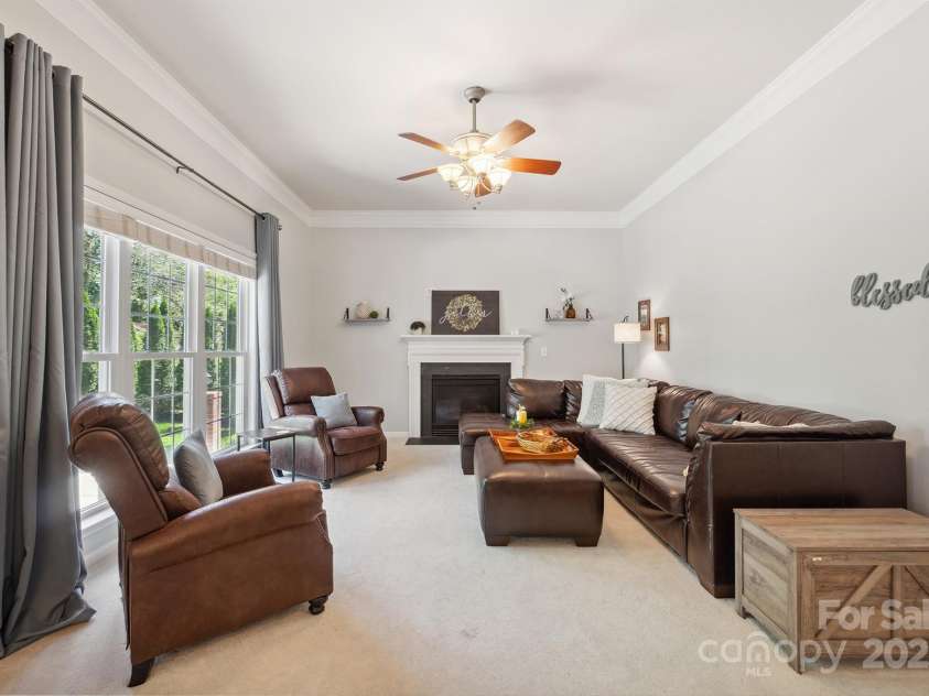 202 Weeping Spring Drive, Mooresville, NC 28115.  MLS# CAR4242789, YatesRealty ID 5224. Family room has cozy gas log fp and lots of windows and light to enjoy the backyard