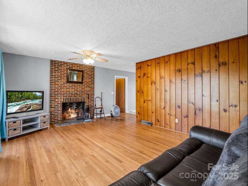 290 Stepp Mill Road, Hendersonville, NC 28792.  MLS# CAR4317367, YatesRealty ID 523. Living Room w/ Wood Burning Fireplace