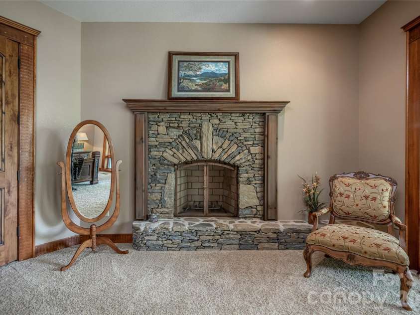 538 Celebration Cove, Clyde, NC 28721.  MLS# CAR4424841, YatesRealty ID 52304. Primary Suite on Main features the quintessential stone fireplace (plumbed for gas) with custom mantle for cozy nights in all four seasons