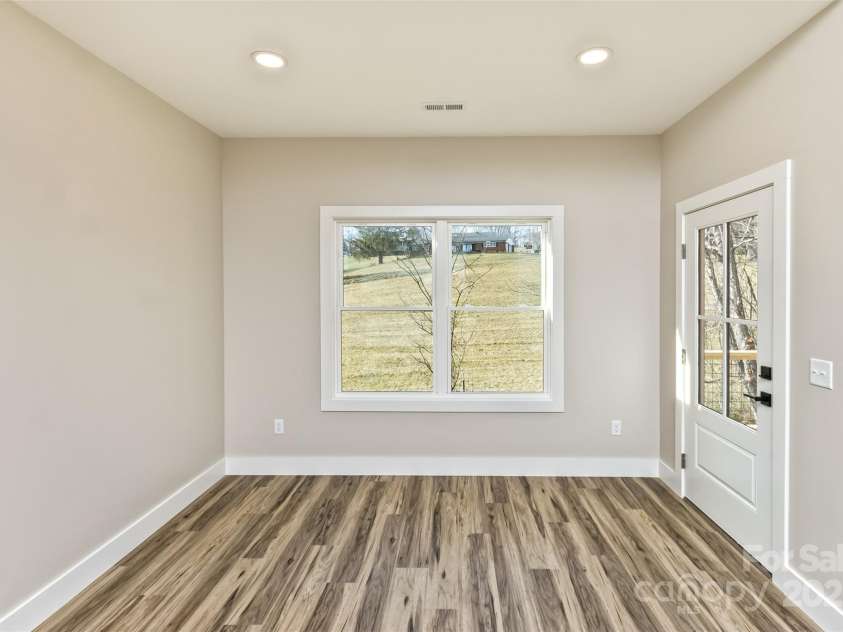 115 Peyton Elaine Road, Clyde, NC 28721.  MLS# CAR4329070, YatesRealty ID 52403. Dining area, door to rear porch