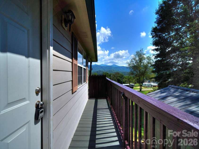 38 Country Lane, Franklin, NC 28734.  MLS# CAR4417927, YatesRealty ID 52434. Front Door and Deck Walkway View