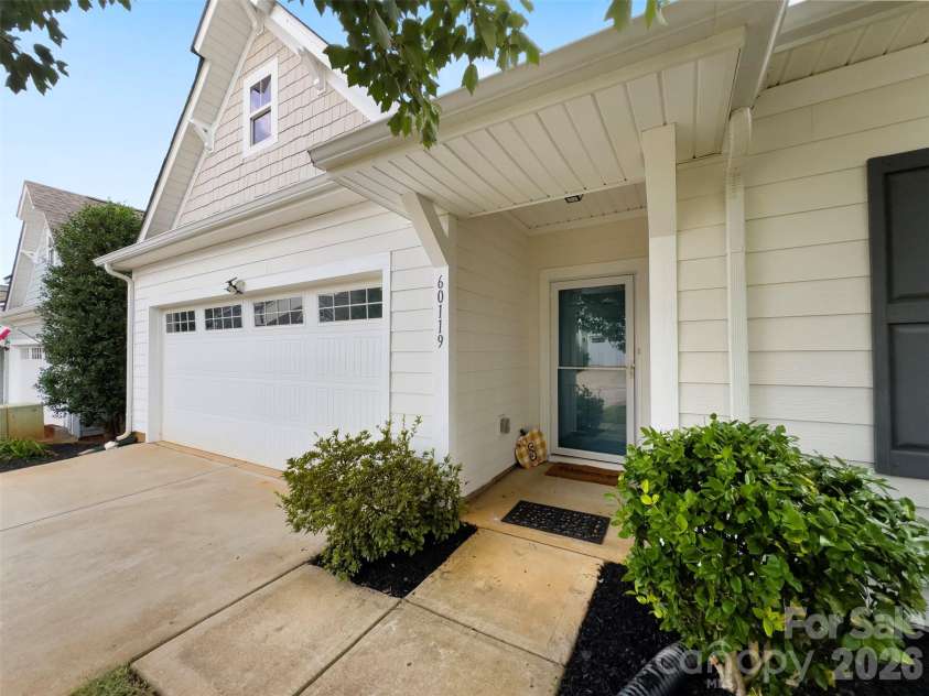60119 Blue Bird Lane, Lancaster, SC 29720.  MLS# CAR4426158, YatesRealty ID 52441. Front of home 2 car garage covered stoop