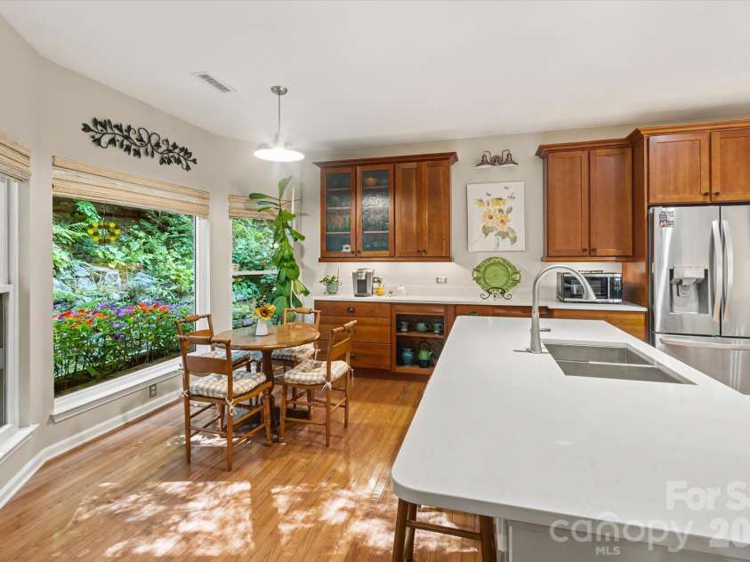 300 Caroline Lane, Pisgah Forest, NC 28768.  MLS# CAR4426646, YatesRealty ID 52453. Breakfast nook overlooking immaculate garden