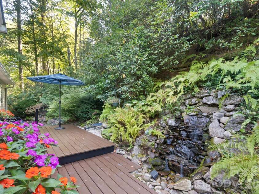 300 Caroline Lane, Pisgah Forest, NC 28768.  MLS# CAR4426646, YatesRealty ID 52453. Calming water fall off back deck