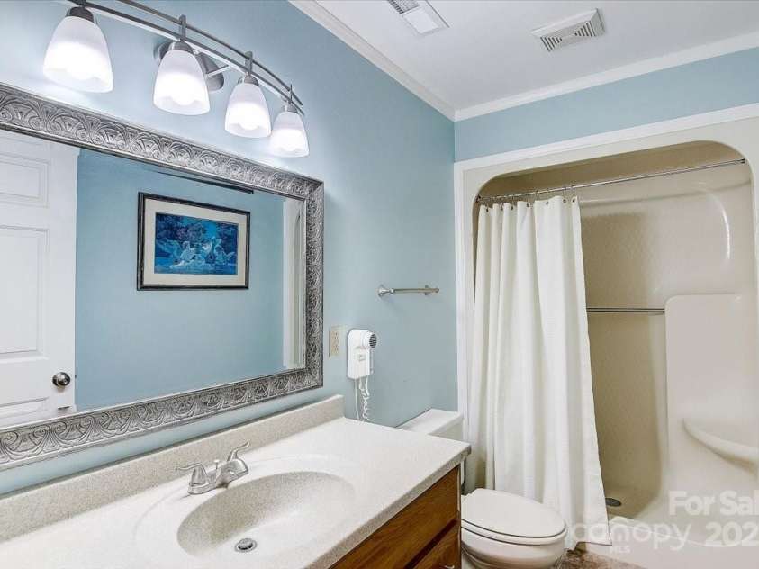 255 Gateway Drive, Lake Lure, NC 28746.  MLS# CAR4138929, YatesRealty ID 525. Guest bathroom in the basement between the guest bonus room with twin beds, and the bunk room. Also accessible from the hallway by the basement-level living room.