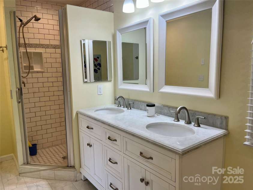 255 Gateway Drive, Lake Lure, NC 28746.  MLS# CAR4138929, YatesRealty ID 525. Main level primary en suite bathroom.
