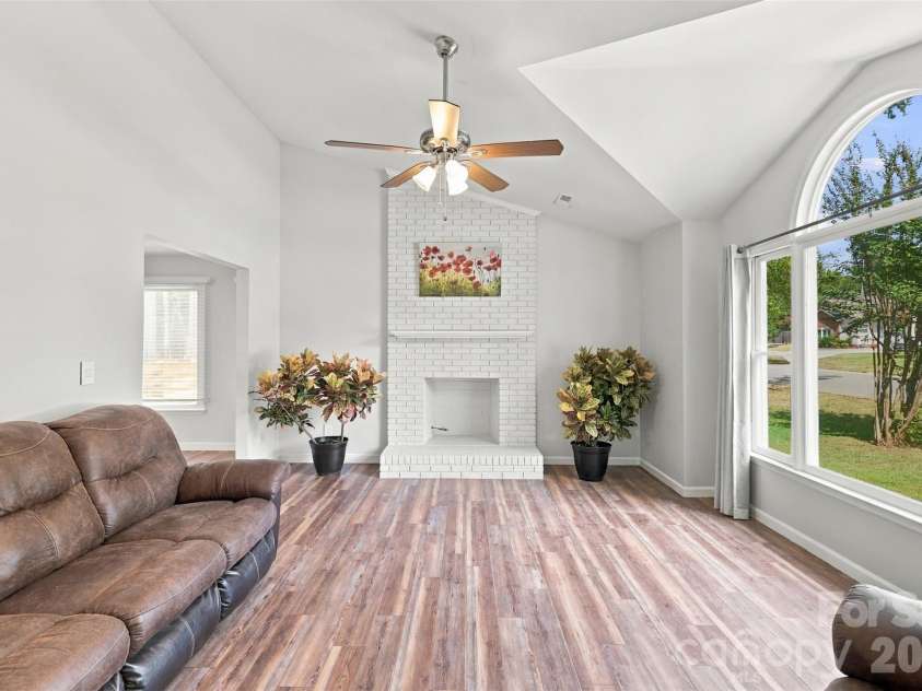 3000 Faircroft Way, Monroe, NC 28110.  MLS# CAR4427543, YatesRealty ID 52533. Cozy living room w/ oversized window, centered around a brick fireplace