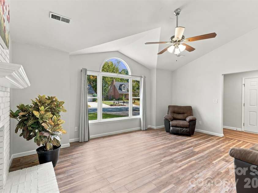 3000 Faircroft Way, Monroe, NC 28110.  MLS# CAR4427543, YatesRealty ID 52533. Cozy living room w/ oversized window, centered around a brick fireplace