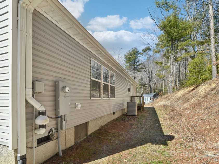 296 Sentelle Lane, Hendersonville, NC 28739.  MLS# CAR4226674, YatesRealty ID 5255. Back of the house complete with quaint back porch